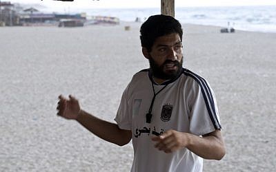 Mohammed Bar, a Palestinian man who works as a lifeguard along the beach in Gaza City speaks as he scans the beach on August 18, 2014. (photo credit:P AFP Photo/Roberto Schmidt)