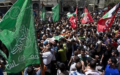 Relatives of 27-year-old Widad Deif, the wife of Hamas's military commander Mohammed Deif, carry her body during her funeral procession at the Jabalia refugee camp in the northern Gaza Strip on August 20, 2014. (photo credit: AFP Photo/Roberto Schmidt)