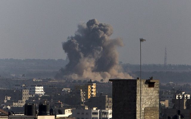 Smoke rises from buildings following an Israeli air strike on Gaza City on August 20, 2014. (photo credit: AFP/MAHMUD HAMS)