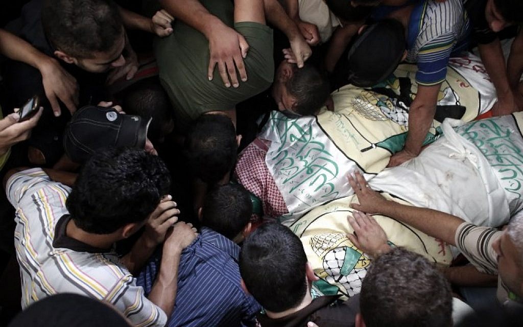 Palestinian Hamas supporters mourn over the bodies of two of the three Hamas senior commanders killed in an Israeli military strike, during their funerals at a mosque in Rafah in the south of the Gaza Strip, on August 21, 2014. (photo credit: AFP Photo/Thomas Coex)