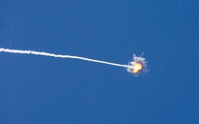 Illustrative: A picture taken from the southern Israeli border with the Gaza Strip shows the trail of a missile launched by Israel's Iron Dome defense system, on August 22, 2014 (AFP Photo/Jack Guez)