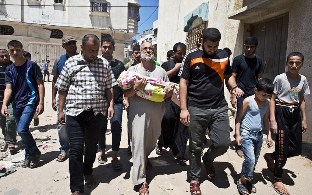 Palestinian Abu Bilal (C) carries the body of his one-and-a-half year old granddaughter during the funeral procession in Gaza City on August 24, 2014. (photo credit: AFP PHOTO/ ROBERTO SCHMIDT)