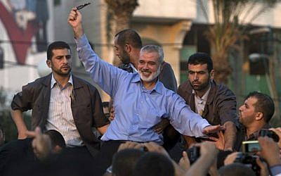 Ismail Haniyeh waves to the crowd during a rally in Gaza City on August 27, 2014. (photo credit: AFP/Mahmud Hams)