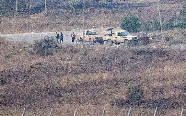 A picture taken from the Golan Heights shows armed men, reportedly rebel fighters, standing near vehicles in the Syrian side of the Golan, near the Quneitra border crossing, on August 28, 2014 (Photo credit: AFP/ JACK GUEZ) A picture taken from the Golan Heights shows armed men, reportedly rebel fighters, standing near vehicles in the Syrian side of the Golan, near the Quneitra border crossing, on August 28, 2014 (Photo credit: AFP/ JACK GUEZ)