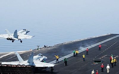 An F/A-18E Super Hornet takes off from the flight deck of the aircraft carrier USS George H.W. Bush (CVN 77)on August 1, 2014 in the Gulf (Photo credit: AFP/US NAVY/Joshua Card)