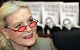 This May 7, 2005 file photo shows US actress Lauren Bacall signing copies of her autobiography at a book shop in Paris, France. (Photo credit: AFP/PIERRE ANDRIEU / Files)
