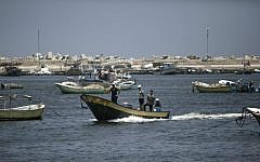 Palestinian fishermen arrive back from fishing in the port of Gaza City on August 5, 2014, after a 72-hour truce agreed by Israel and Hamas went into effect. (AFP/Mahmud Hams)