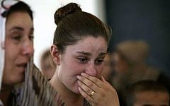 An Iraqi Yazidi woman who fled the violence in the northern Iraqi town of Sinjar, cries as she stands among others at a school where they are taking shelter in the Kurdish city of Dohuk in Iraq's autonomous Kurdistan region, on August 5, 2014. (photo credit: AFP/SAFIN HAMED)