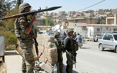 Lebanese troops stand guard in a street on August 9, 2014, in the eastern Lebanese town of Arsal, on the border with Syria. (photo credit: AFP/STR)