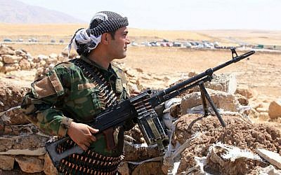 File: An Iraqi Kurdish peshmerga fighter takes up position in the town of Bashiqa, 13 kilometers northeast of Mosul, on August 12, 2014. (AFP/Ahmad al-Rubaye)