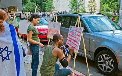In New York's Village, passersby participate in the Artists 4 Israel 'Art Vigil' as a pro-Israel rally takes place in the next block. (courtesy)