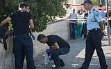 Security personnel at the scene where a gunman on a motorcycle opened fire at a soldier near Jerusalem's Hebrew University on Mt. Scopus, August 4, 2014 (photo credit: Yonatan Sindel/Flash90)