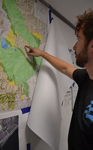 An IsraAid worker plots the groups movements for the day. (Emily Alhadeff/The Times of Israel)