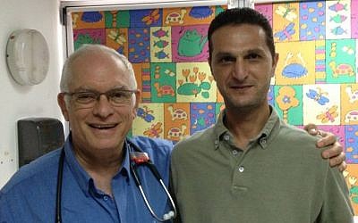 Akiva Tamir left) and Khaled Obeid at Wolfson Hospital in Holon, August 12, 2014 photo credit: Elhanan Miller/Times of Israel staff)