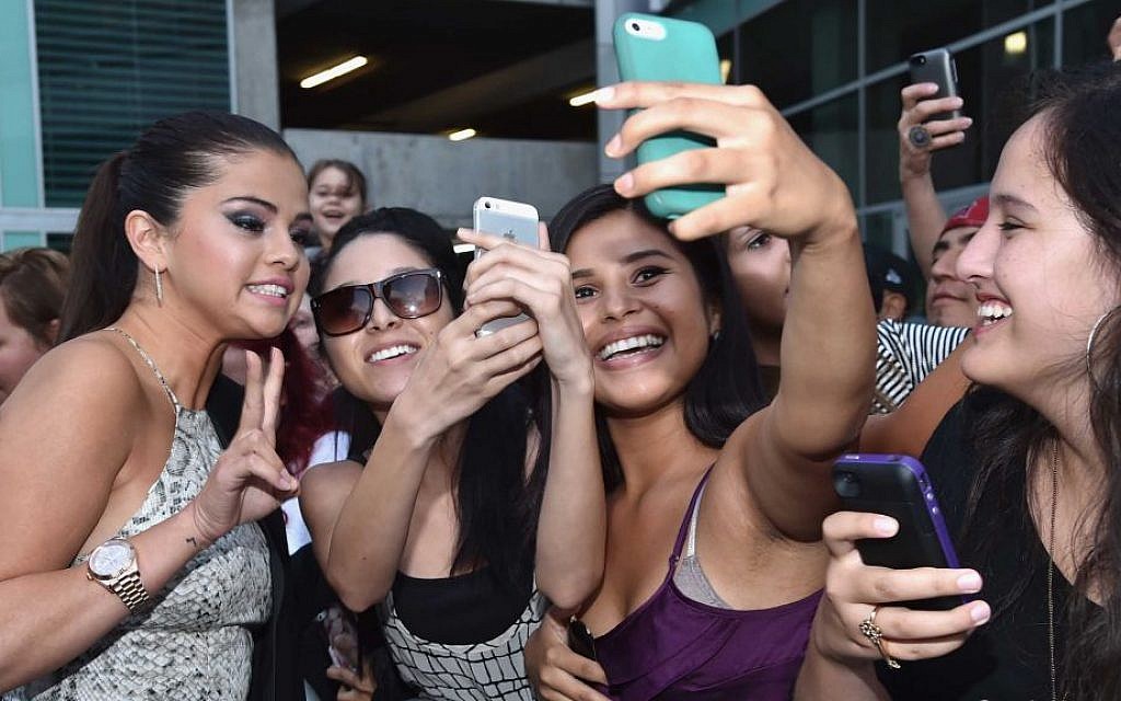 Selena Gomez, left, arriving at the premiere of Mad Chance’s 'Behaving Badly' at the ArcLight Cinema in Hollywood, Calif., July 29, 2014 . (Alberto E. Rodriguez/Getty Images/JTA) Selena Gomez, left, arriving at the premiere of Mad Chance’s 'Behaving Badly' at the ArcLight Cinema in Hollywood, Calif., July 29, 2014 . (Alberto E. Rodriguez/Getty Images/JTA)