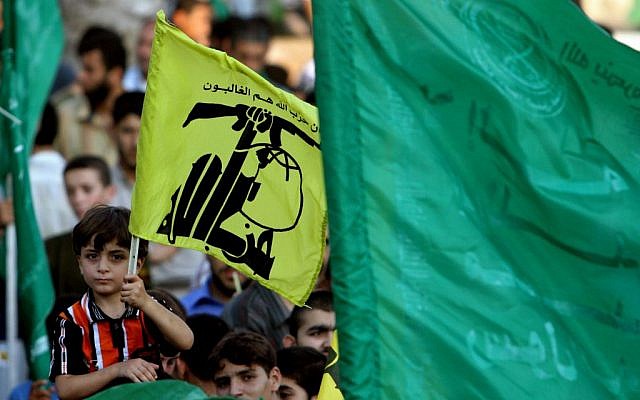 Hamas supporters in Gaza hold Hezbollah and Islamic flags as they demonstrate against the Israeli offensive in Lebanon, July 30, 2006. (photo credit: AP/Khalil Hamra)
