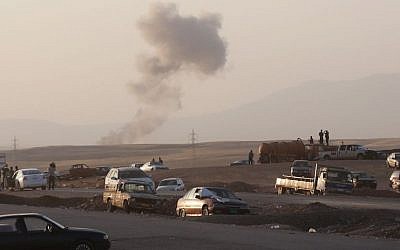 Smoke rises after airstrikes targeting Islamic State militants near the Khazer checkpoint outside of the city of Irbil in northern Iraq, Friday, Aug. 8, 2014. (Photo credit: AP/ Khalid Mohammed) Smoke rises after airstrikes targeting Islamic State militants near the Khazer checkpoint outside of the city of Irbil in northern Iraq, Friday, Aug. 8, 2014. (Photo credit: AP/ Khalid Mohammed)