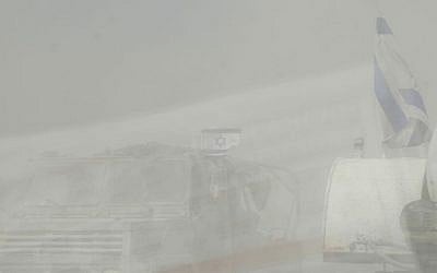 Dust kicked up by moving military vehicles made it tough to drive in southern Israel near the Gaza border on Tuesday.  (photo credit: Melanie Lidman/Times of Israel)