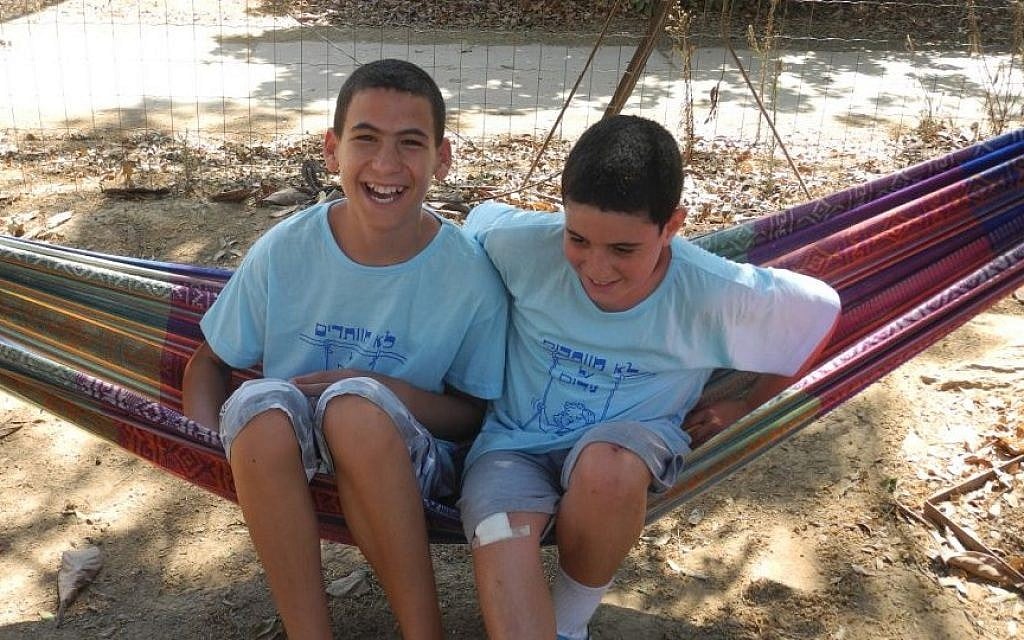 Brothers Regev (left) and Barak (right) Haglili, from Kibbutz Nirim in southern Israel, are thrilled to be back home despite frequent rockets, after spending the war in northern Israel with other children from the kibbutz. (photo credit: Melanie Lidman/Times of Israel) Brothers Regev (left) and Barak (right) Haglili, from Kibbutz Nirim in southern Israel, are thrilled to be back home despite frequent rockets, after spending the war in northern Israel with other children from the kibbutz. (photo credit: Melanie Lidman/Times of Israel)