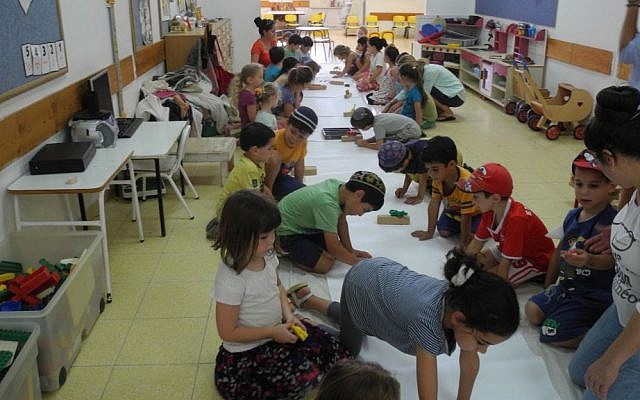 Child from Kibbutz Alumim in southern Israel made a mural of animals that make them feel strong with Artists 4 Israel on Wednesday. (Melanie Lidman/Times of Israel) Child from Kibbutz Alumim in southern Israel made a mural of animals that make them feel strong with Artists 4 Israel on Wednesday. (Melanie Lidman/Times of Israel)