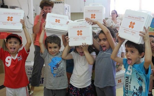 Kids at Kibbutz Alumim with the emergency art kits distributed by Artists 4 Israel. (Melanie Lidman/Times of Israel) Kids at Kibbutz Alumim with the emergency art kits distributed by Artists 4 Israel. (Melanie Lidman/Times of Israel)