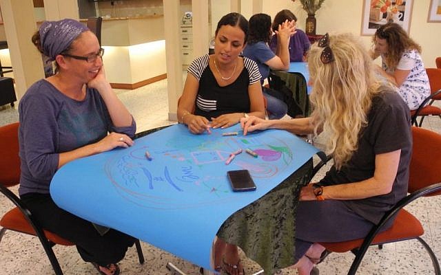 Parents from Kibbutz Alumim in southern Israel did their own art therapy with Artists 4 Israel, and then learned how to use the emergency art kits after sirens. (Melanie Lidman/Times of Israel) Parents from Kibbutz Alumim in southern Israel did their own art therapy with Artists 4 Israel, and then learned how to use the emergency art kits after sirens. (Melanie Lidman/Times of Israel)