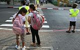 Illustrative: Schoolchildren waiting to cross a street. (Liron Almog/Flash90)