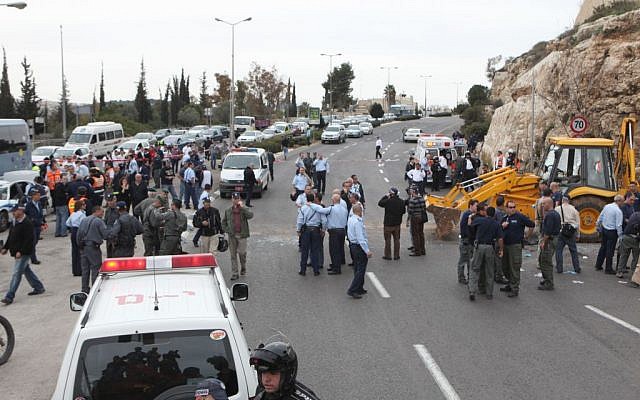 Israeli police officers and emergency personnel at the scene where a terrorist tractor driver slammed into vehicles in Jerusalem March 5, 2009. (Photo credit: Yossi Zamir/Flash90) Israeli police officers and emergency personnel at the scene where a terrorist tractor driver slammed into vehicles in Jerusalem March 5, 2009. (Photo credit: Yossi Zamir/Flash90)