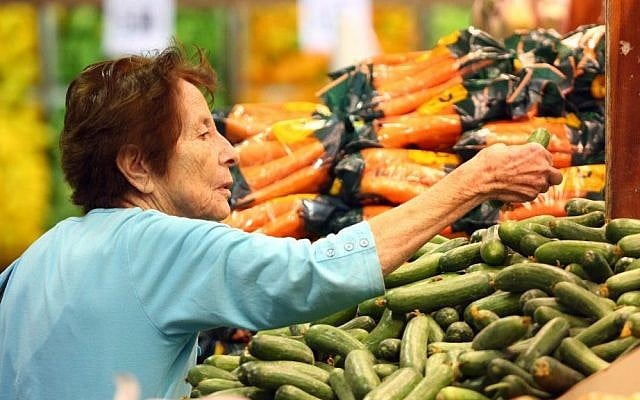 Illustrative photo of a woman shopping for produce in a supermarket. (Abir Sultan/Flash90)