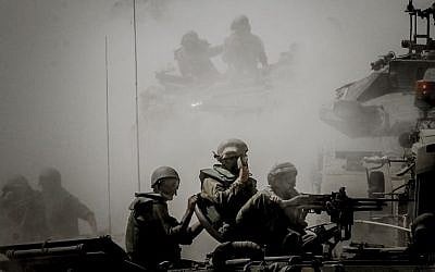 Israeli soldiers seen on tanks at an IDF staging area near the Israeli border with Gaza, on July 31, 2014. (photo credit: Miriam Alster/Flash90)