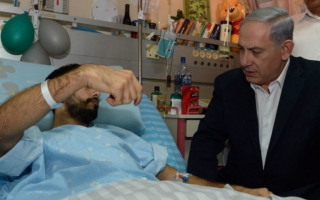 Prime Minister Benjamin Netanyahu visits Israeli soldiers who were injured during Israel's Operation Protective Edge, at the Soroka Medical center in Beersheba on August 04, 2014. (Photo credit: Haim Zach / GPO/FLASH90) Prime Minister Benjamin Netanyahu visits Israeli soldiers who were injured during Israel's Operation Protective Edge, at the Soroka Medical center in Beersheba on August 04, 2014. (Photo credit: Haim Zach / GPO/FLASH90)