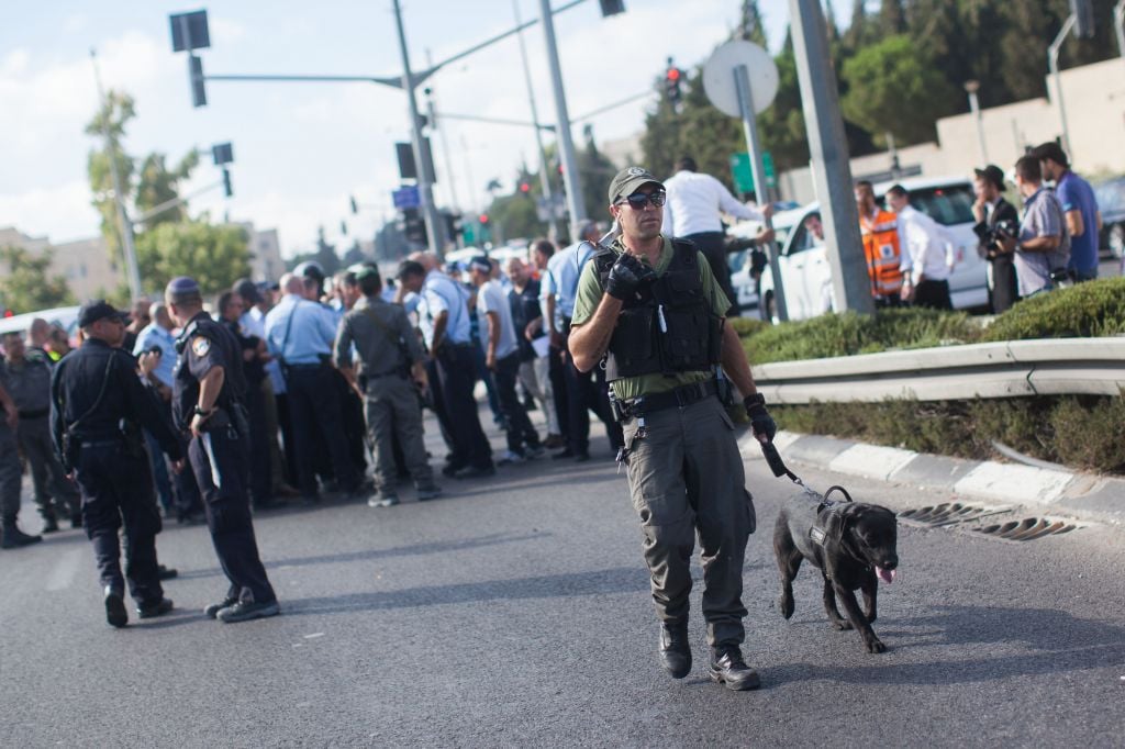 Security personnel at the scene where a gunman on a motorcycle opened fire on soldier Chen Schwartz, near Jerusalem's Hebrew University on Mt. Scopus, August 4, 2014. (Photo credit: Yonatan Sindel/Flash90) Security personnel at the scene where a gunman on a motorcycle opened fire on soldier Chen Schwartz, near Jerusalem's Hebrew University on Mt. Scopus, August 4, 2014. (Photo credit: Yonatan Sindel/Flash90)