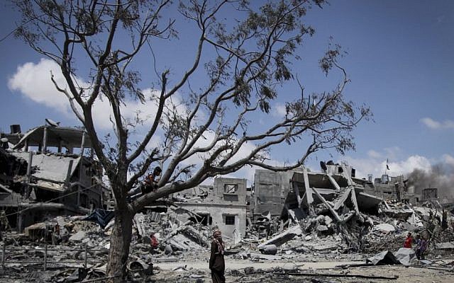 Palestinians collect their belongings from homes destroyed by Israeli shelling in the northern Gaza Strip town of Beit Lahiya, Tuesday, August 4, 2014. (photo credit: Emad Nasser/Flash90) Palestinians collect their belongings from homes destroyed by Israeli shelling in the northern Gaza Strip town of Beit Lahiya, Tuesday, August 4, 2014. (photo credit: Emad Nasser/Flash90)