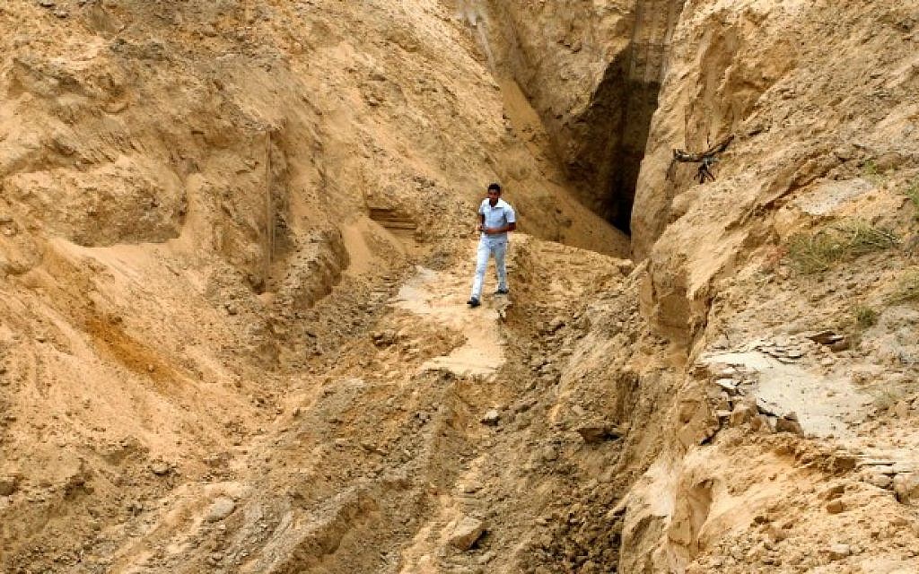 A Palestinian man looks at what used to be a tunnel leading from the Gaza Strip into Israel, in the area of Rafah in the southern Gaza Strip, on August 5, 2014 (Abed Rahim Khatib/Flash90)