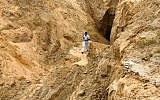 A Palestinian man looks at what used to be a tunnel leading from the Gaza Strip into Israel, in the area of Rafah in the southern Gaza Strip, on August 5, 2014 (Abed Rahim Khatib/Flash90)