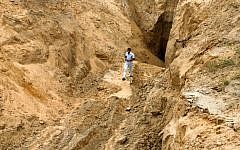 A Palestinian man looks at what used to be a tunnel leading from the Gaza Strip into Israel, in the area of Rafah in the southern Gaza Strip, on August 5, 2014 (Abed Rahim Khatib/Flash90)