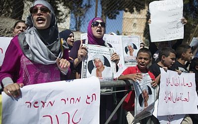 Arab protesters hold placards during a demonstration in support of the family of slain East Jerusalem teen Muhammed Abu Khdeir outside the Jerusalem District Court, Wednesday, August 6, 2014. (photo credit: Yonatan Sindel/Flash90) Arab protesters hold placards during a demonstration in support of the family of slain East Jerusalem teen Muhammed Abu Khdeir outside the Jerusalem District Court, Wednesday, August 6, 2014. (photo credit: Yonatan Sindel/Flash90)