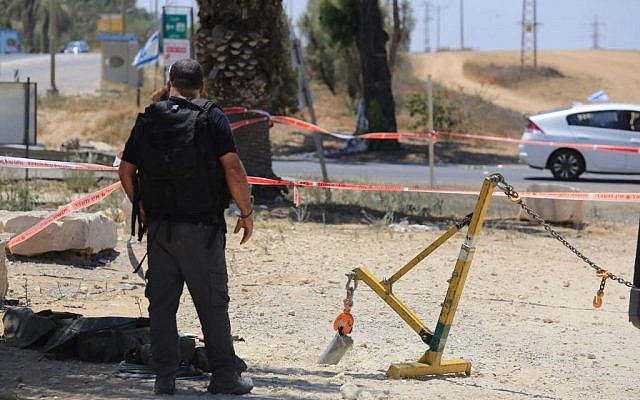 Police sappers inspect a part of a rocket that exploded inside Israel near the border with the Gaza Strip on August 8, 2014.  (photo credit: Edi Israel/Flash90)