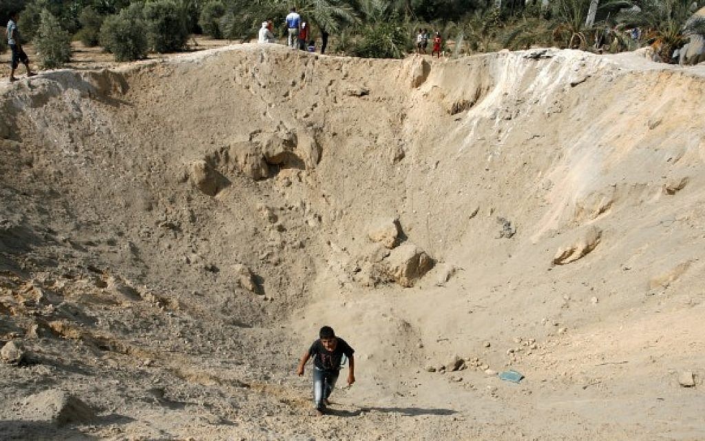 Palestinians inspect the damage after an Israeli air strike in the east of the town of Khan Younis in the southern Gaza Strip on August 14, 2014. (Photo credit: Abed Rahim Khatib/Flash90)