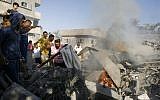 Palestinians gather around the rubble of a house, which witnesses said was destroyed in an Israeli air strike, in Rafah in the southern Gaza Strip on August 20, 2014. (photo credit: Abed Rahim Khatib/Flash90)