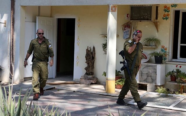 soldiers seen at a kindergarten that was directly hit by a mortar fired from Gaza, in the Eshkol region of southern Israel, August 21, 2014. Jan Berman, a 33-year-old man, was injured from the explosion. (Photo credit: Flash90)