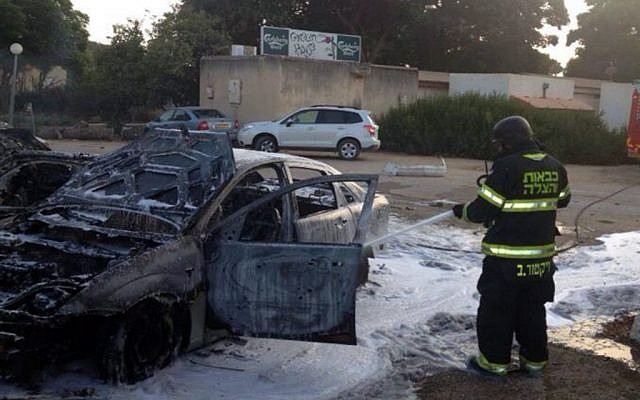 Firefighters try to extinguish the fire where a rocket landed and killed a 4-year-old boy at a kibbutz in southern Israel on August 22, 2014 (Photo credit: Southern Region Fire Department Spokesperson)