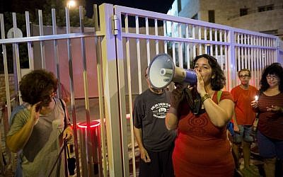 Residents from communities near the Gaza border hold candles as they protest near the Prime Minister's Residence in Jerusalem on August 22, 2014, demanding peace and quiet for their communities. (Photo credit: Yonatan Sindel/Flash90)