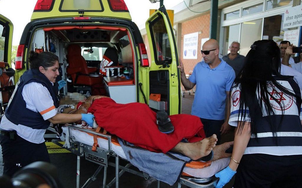 A man injured by a mortar shell is rushed to the emergency room after arriving at Barzilai Hospital in Ashkelon on August 24, 2014. (photo credit: Edi Israel/Flash90)