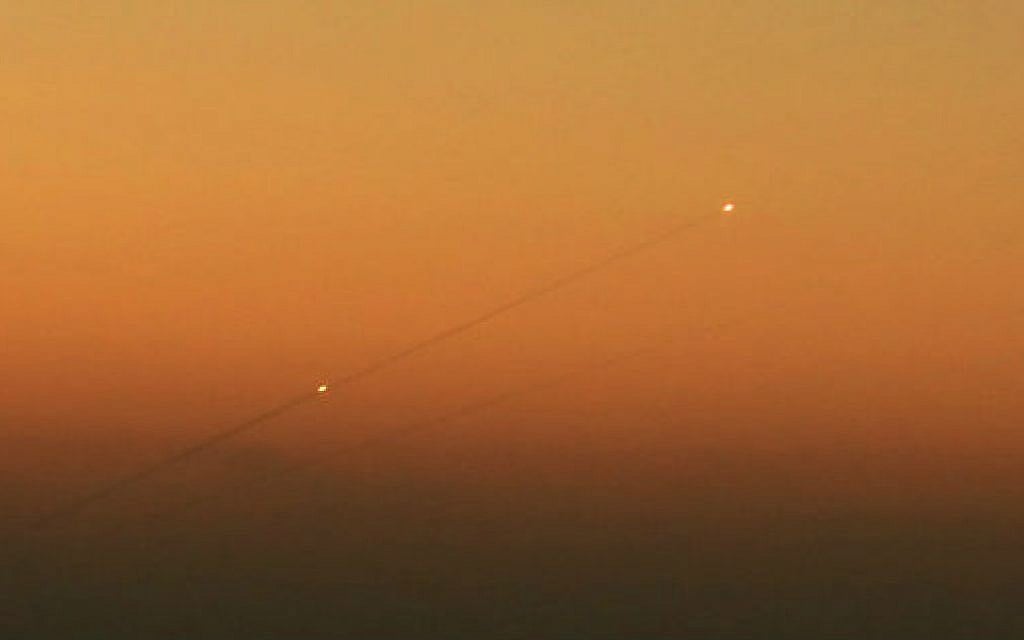 Illustrative. A trail of smoke is seen as rockets launched from the Gaza Strip streak towards the southern Israeli city of Ashkelon on August 24, 2014. (Edi Israel /Flash90/File)