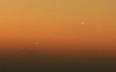 A trail of smoke is seen as rockets launched from the Gaza Strip streak towards the southern Israeli city of Ashkelon on August 24, 2014. (photo credit: Edi Israel /Flash90)