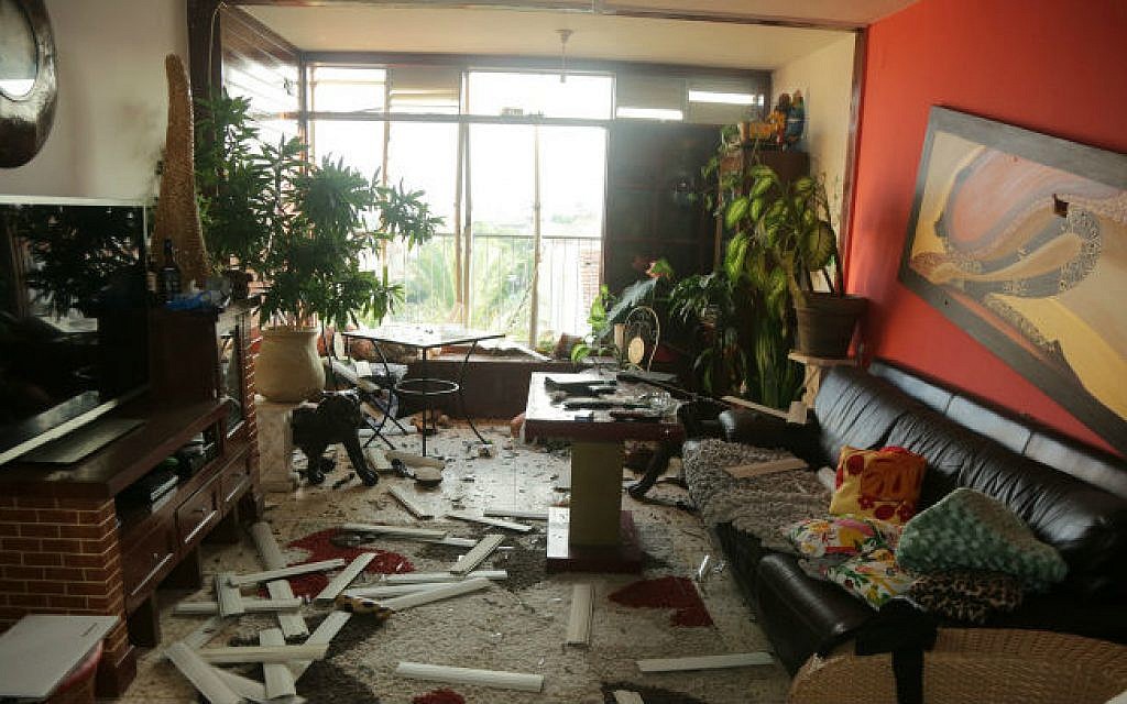 An apartment building that was damaged by the explosion from a rocket, fired in the Gaza Strip, which hit a neighboring house in Ashkelon, southern Israel, early morning on August 26, 2014. (photo credit: Edi Israel/Flash90)