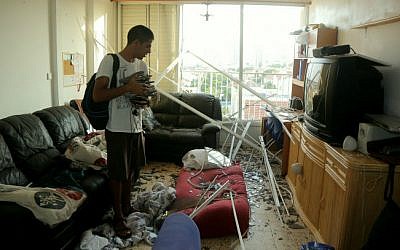 An apartment building that was damaged by the explosion from a rocket, fired in the Gaza Strip, which hit a neighboring house in Ashkelon, southern Israel, early morning on August 26, 2014.  (photo credit: Edi Israel/Flash90)