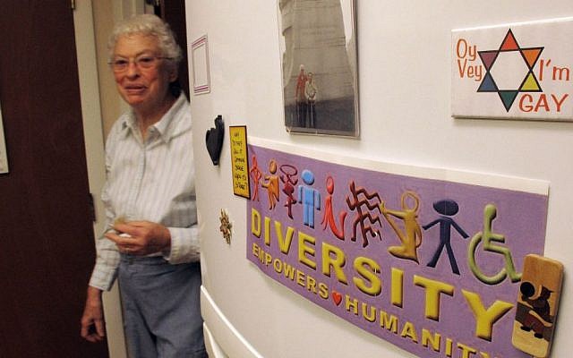 Lennie Gerber walks near the Gay Pride magnets and bumper stickers that decorate the refrigerator at her home in High Point, N.C. (AP Photo/Allen G. Breed)