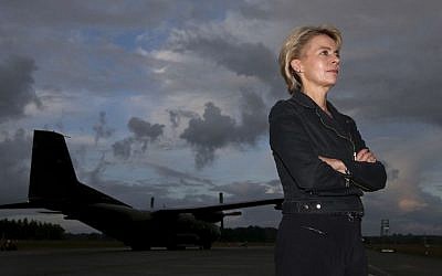 German Defense Minister Ursula von der Leyen stands in front of a Transall transport aircraft of German Bundeswehr at the airfield Hohn in Alt Duvenstedt, Germany, Friday, August 15, 2014. (AP Photo/Axel Heimken, pool)